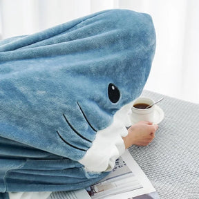 CozyShark wearable shark blanket Person enjoying CozyShark brand shark blanket Comfortable CozyShark shark blanket Unique CozyShark wearable blanket CozyShark shark blanket for cozy nights Fashionable shark-themed CozyShark blanket CozyShark blanket for kids and adults Warm and snuggly CozyShark shark blanket Fun CozyShark wearable blanket CozyShark brand shark blanket for lounging