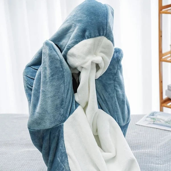 CozyShark wearable shark blanket Person enjoying CozyShark brand shark blanket Comfortable CozyShark shark blanket Unique CozyShark wearable blanket CozyShark shark blanket for cozy nights Fashionable shark-themed CozyShark blanket CozyShark blanket for kids and adults Warm and snuggly CozyShark shark blanket Fun CozyShark wearable blanket CozyShark brand shark blanket for lounging